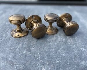 Two pairs of antique style door knobs with round backplate.