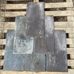 A display of mixed roof slates showing variations of colour and texture.