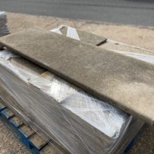 A natural stone slab, well weathered with a bullnose front edge.