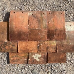 A display of reclaimed Sussex peg tiles showing the variations in colour and texture.