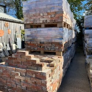 A palleted batch of hand-cleaned reclaimed traditional Ashburnham blue headed bricks at our Sussex yard.