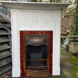 An original Edwardian combination fireplace with brown glazed tiles in unrestored condition.
